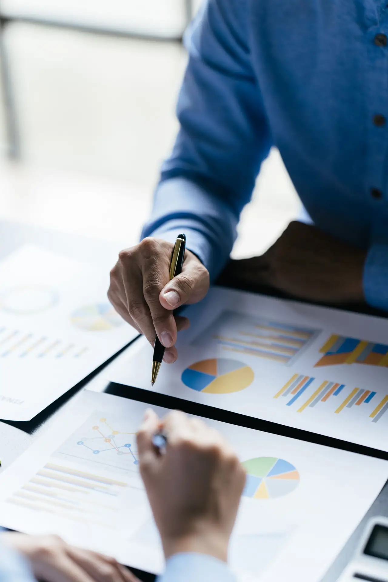 Business team reviewing a diagram or chart and financial reports for a return on investment or investment risk analysis or business performance.